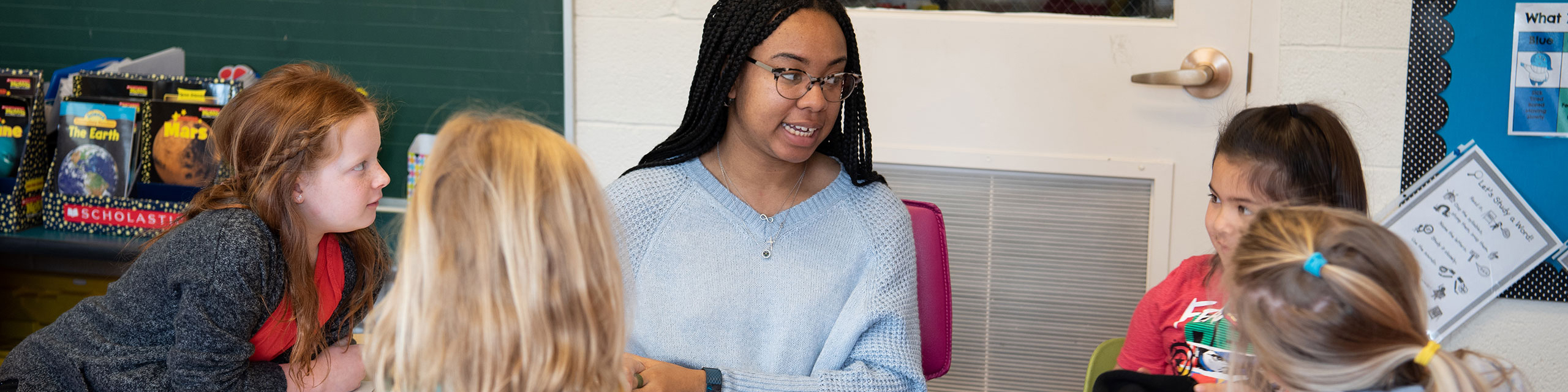 Teacher speaking in front of the class.