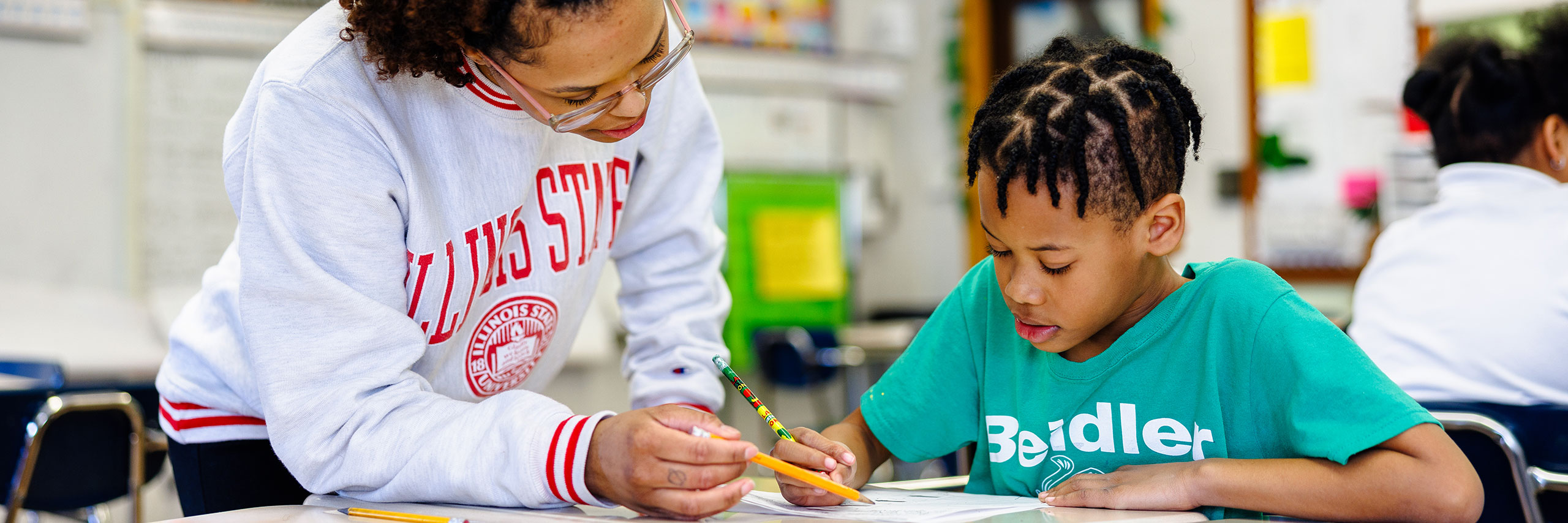 Teacher helping a student understand an assignment