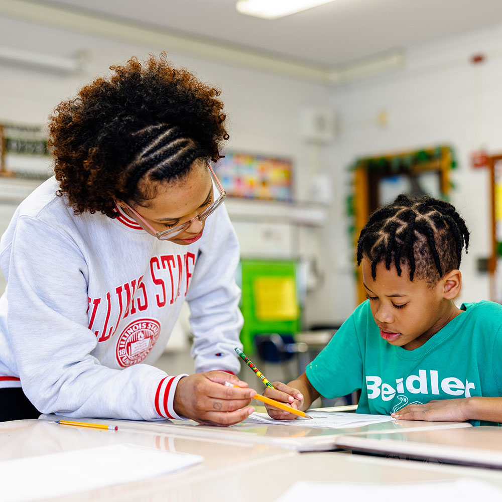 Teacher helping a student understand an assignment